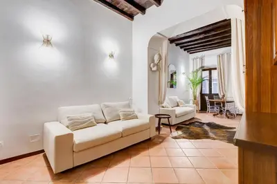 a living room with a couch and a table at GIULIO CESARE DELUXE - Spanish Step RomeDreamHome in Rome