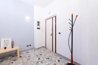 a hallway with a table and a door in a room at Casa Di Cristina in Rome