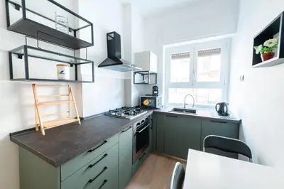 a kitchen with green cabinets and a stove top oven at Casa Di Cristina in Rome