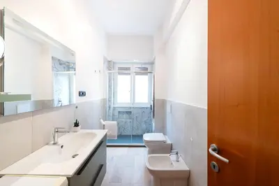 a white bathroom with a sink and a toilet at Casa Di Cristina in Rome