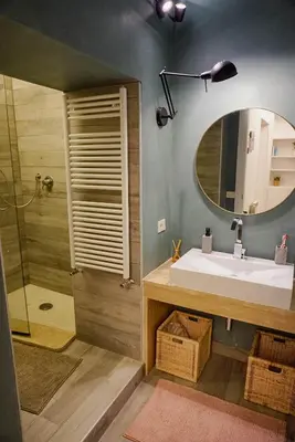 a bathroom with a sink and a mirror and a shower at Seminterrato al Pıgneto metro C in Rome