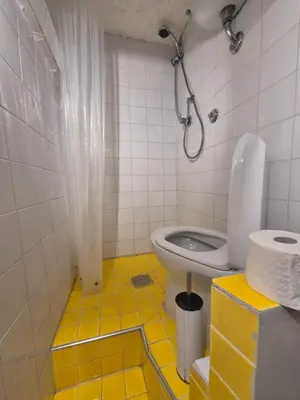a bathroom with a shower and a toilet in it at Seminterrato al Pıgneto metro C in Rome