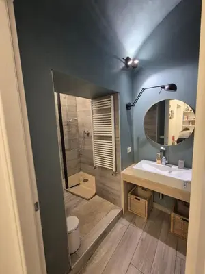 a bathroom with a shower and a sink and a mirror at Seminterrato al Pıgneto metro C in Rome