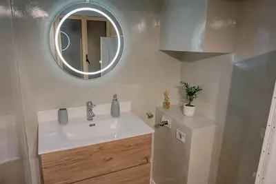 a bathroom with a sink and a mirror at Seminterrato al Pıgneto metro C in Rome