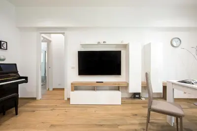 a living room with a television and a piano at Domus Ascanio by the Vatican in Rome