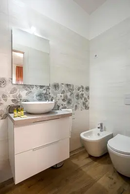 a bathroom with two sinks and a toilet and a mirror at Domus Ascanio by the Vatican in Rome
