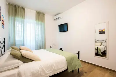 a bedroom with a bed and a tv on the wall at Domus Ascanio by the Vatican in Rome