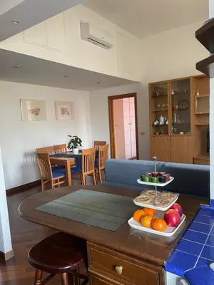 a living room with a table with fruit on it at Sun's House in Rome