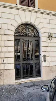 a door with a metal gate on a building at Sun's House in Rome
