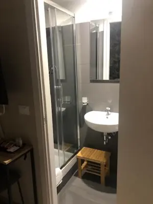 a bathroom with a glass shower and a sink at Guest House Prime Palace in Rome