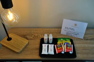 a table with a black tray with toothbrushes and a sign at Guest House Prime Palace in Rome
