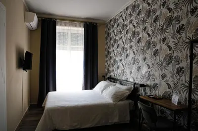 a small bedroom with a bed and a window at Guest House Prime Palace in Rome