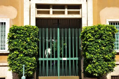 a green gate in the middle of a building at Guest House Prime Palace in Rome