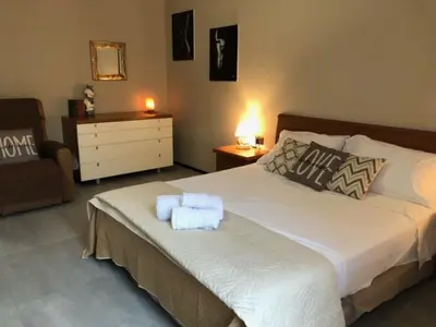 a bedroom with a bed with towels on it at Interno 18 - appartamento a San Giovanni in Rome