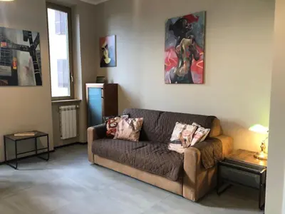 a living room with a brown couch in a room at Interno 18 - appartamento a San Giovanni in Rome