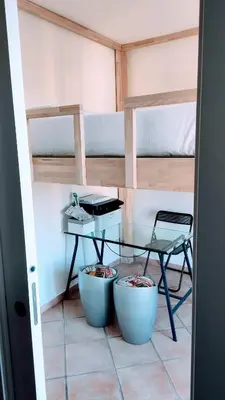 a room with a table and two bunk beds at Attic Roof Oasi Vaticana in Rome