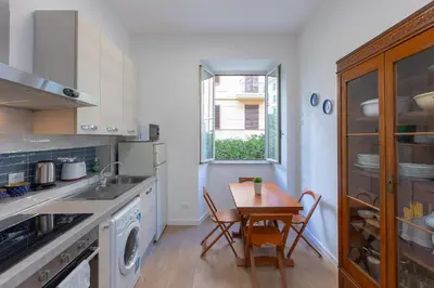 a kitchen with a table and a sink and a window at Faleria by Rental in Rome in Rome