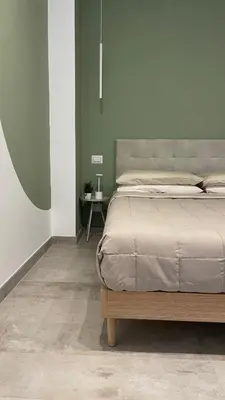 a bedroom with a large bed and a table at 633 APPIA DESIGN ROOM in Rome