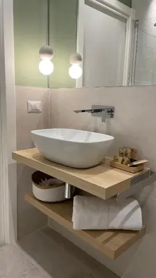 a bathroom with a large white sink on a counter at 633 APPIA DESIGN ROOM in Rome