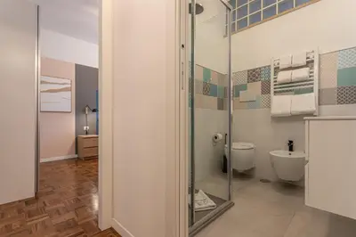 a bathroom with a toilet and a glass shower at YCH-Bright and cozy flat in Pigneto in Rome