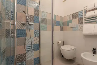 a bathroom with a shower and a toilet and a sink at YCH-Bright and cozy flat in Pigneto in Rome
