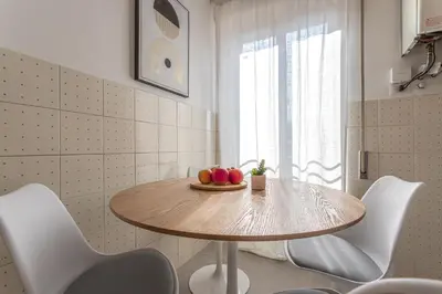 a table in a kitchen with a bowl of apples on it at YCH-Bright and cozy flat in Pigneto in Rome