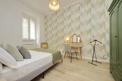 a bedroom with a bed and a table with a desk at YCH-Grazioso Bilocale vicino al Vaticano in Rome