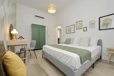 a bedroom with a large bed with a desk and a desk at YCH-Grazioso Bilocale vicino al Vaticano in Rome