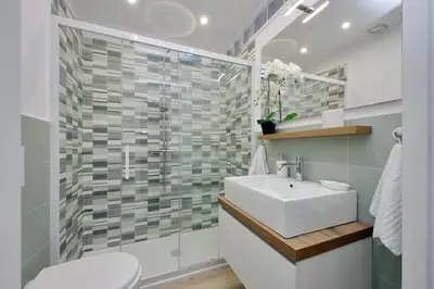 a bathroom with a sink and a glass shower at YCH-Grazioso Bilocale vicino al Vaticano in Rome