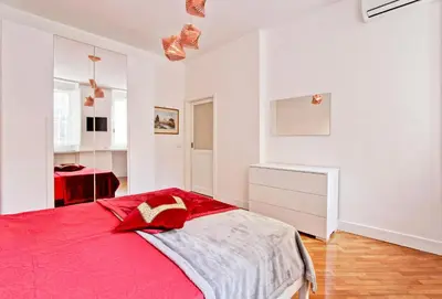 a bedroom with a red bed in a white room at Piazza Navona - Roma Centro Storico in Rome