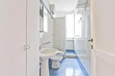 a white bathroom with a toilet and a sink at Piazza Navona - Roma Centro Storico in Rome