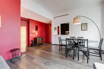 a dining room with red walls and a table and chairs at Music Bridge Apartment in Rome