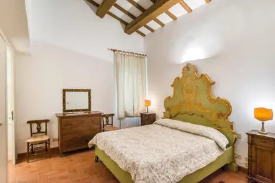 a bedroom with a bed and a dresser and a mirror at Antica Dimora al Vaticano in Rome