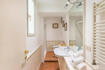 a white bathroom with a sink and a toilet at Antica Dimora al Vaticano in Rome