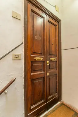 a wooden door in the corner of a room at Antica Dimora al Vaticano in Rome