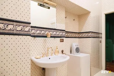 a bathroom with a sink and a mirror at Pantera Holiday House in Rome