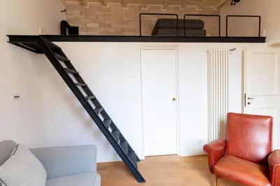 a living room with a loft bed and a couch at Casa Cecilia Roma in Rome