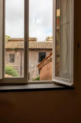 an open window with a view of an old building at Casa Cecilia Roma in Rome