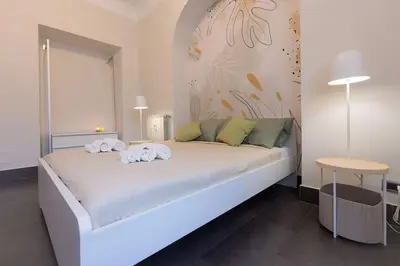 a bedroom with a bed with towels on it at MC Apartment San Giovanni in Rome