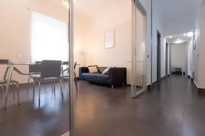 a living room with a couch and a table at MC Apartment San Giovanni in Rome
