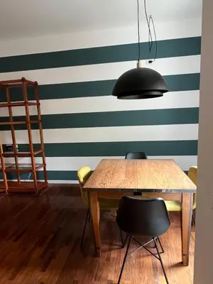 a dining room with green and white stripes at Orti18 - Ponte Milvio in Rome