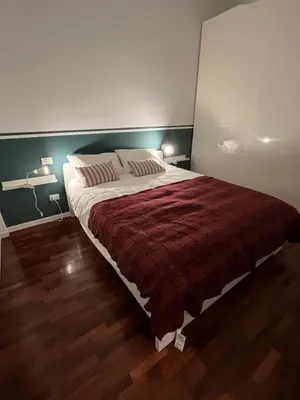 a bedroom with a large bed with a red blanket at Orti18 - Ponte Milvio in Rome