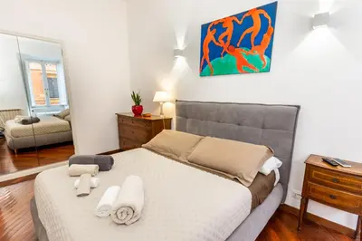 a bedroom with a bed with towels on it at Luxury Apartment - Centro Storico San Pietro in Rome