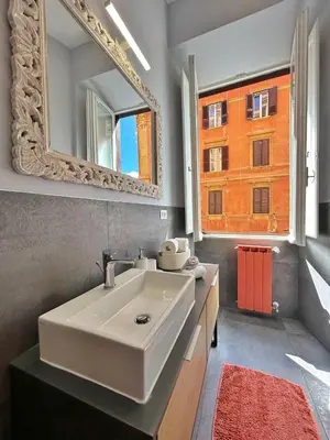 a bathroom with a white sink and a mirror at Luxury Apartment - Centro Storico San Pietro in Rome