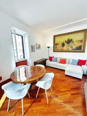 a living room with a table and a couch at Luxury Apartment - Centro Storico San Pietro in Rome