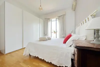 a white bedroom with a white bed and a window at YCH-Confortevole appartamento vicino Ponte Milvio in Rome