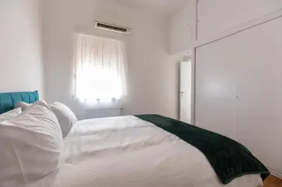 a bedroom with a white bed and a window at Emerald - in the heart of Trastevere in Rome