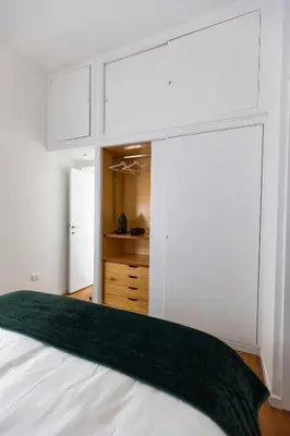 a bedroom with white cabinets and a bed at Emerald - in the heart of Trastevere in Rome