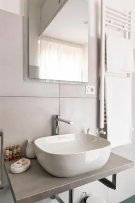 a bathroom with a white sink and a mirror at Emerald - in the heart of Trastevere in Rome