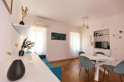 a living room with a table and chairs and a dining room at Emerald - in the heart of Trastevere in Rome